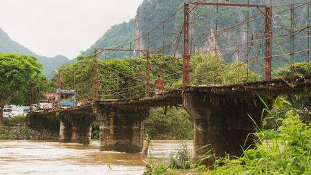 local sling and concrete bridge in vangvieng laosの写真素材