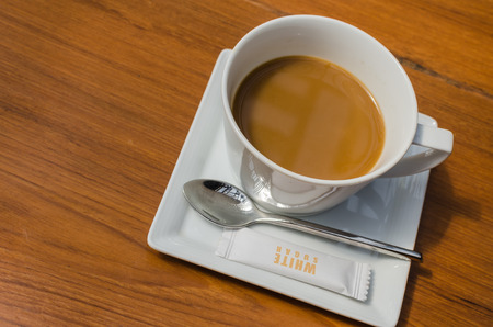 A cup of hot coffee on the table with sugarの写真素材