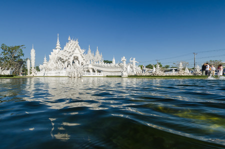 CHIANGRAI, THAILAND - FEB 2 : Unidentified travelers visit Wat Rong Khun a most famous white temple in the North of Thailand on February 2, 2014 at Wat Rong Khun, Chiangrai, Thailand.のeditorial素材