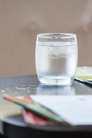 Glass of water on wood tableの写真素材