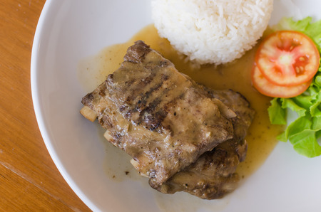 pork with rice and salad on plateの写真素材