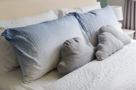 bed and pillows in bedroomの写真素材