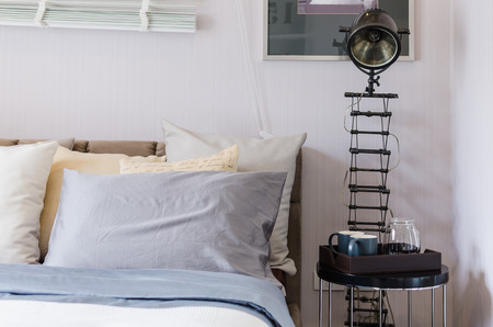 bedroom with pillows and modern lamp at homeの写真素材