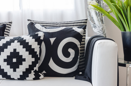 black and white pattern pillows on white sofa at homeの写真素材