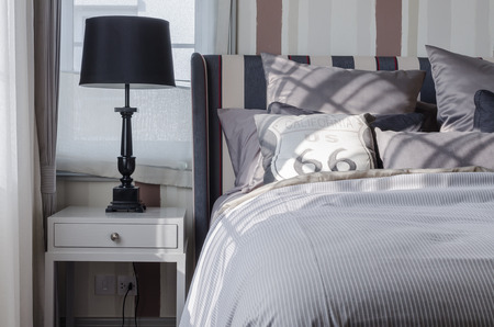 black lamp on grey table in bedroom at homeの写真素材