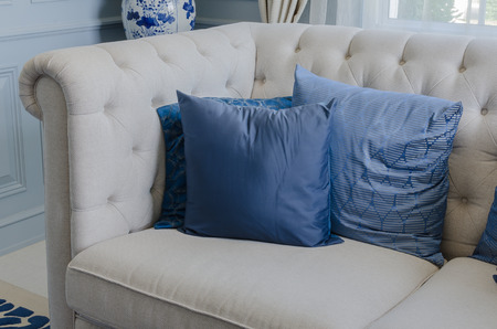 blue pillows on white sofa in luxury living roomの写真素材