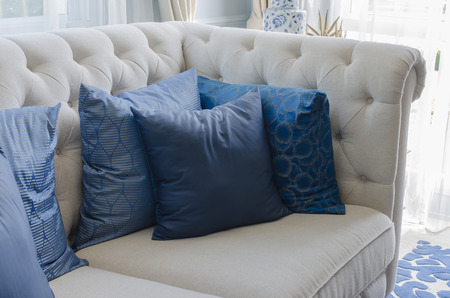 blue pillows on white sofa in luxury living room at homeの写真素材