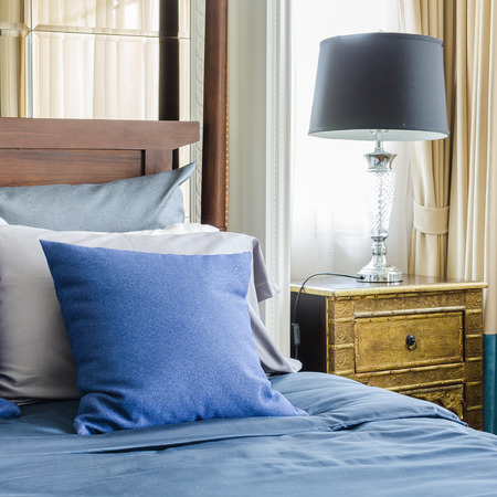 blue pillows on wooden classic bed at homeの写真素材