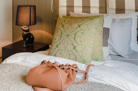 brown bag on bed in bedroom at homeの写真素材
