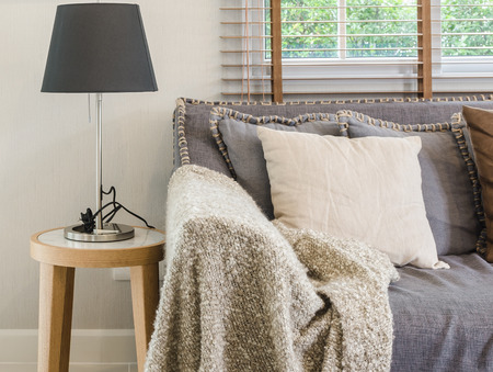 brown blanket on sofa with lamp in living room at homeの写真素材