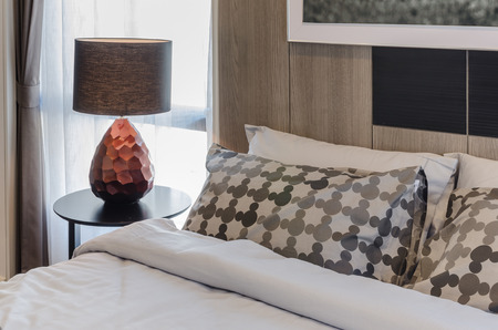 brown lamp on wooden round table in bedroom at homeの写真素材