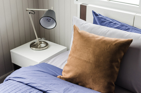 brown pillow on modern bed with lamp at homeの写真素材