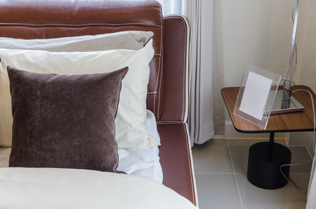 brown pillow on modern bed in bedroomの写真素材