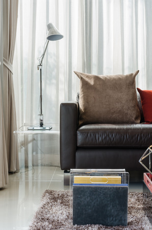 brown pillow on modern sofa with lamp in living roomの写真素材