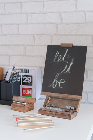 chalkboard on white desk at homeの写真素材