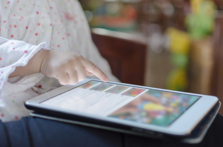 Children play on digital tabletの写真素材