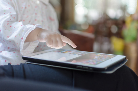 Children playing on digital tablet at homeの写真素材