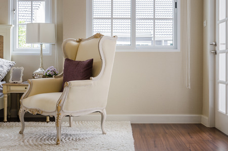 classic chair on carpet with pillow in bedroom at homeの写真素材