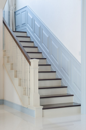 classic style wooden stair with white railing at homeの写真素材