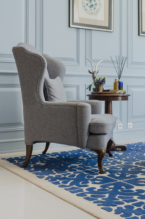 classical grey chair style on blue pattern carpet at homeの写真素材