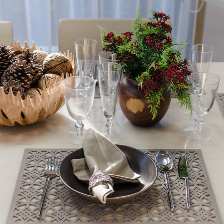 earth tone table set with flower in dinning room at homeの写真素材