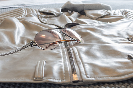 fashion sunglasses on leather brown jacketの写真素材