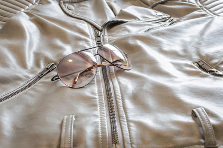 fashion sunglasses on brown jacketの写真素材