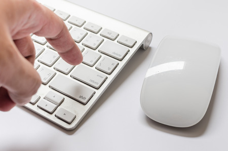 Finger pushing the button of keyboard and mouseの写真素材