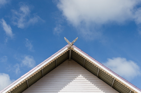 gable roof of a house in front of the blue skyの写真素材