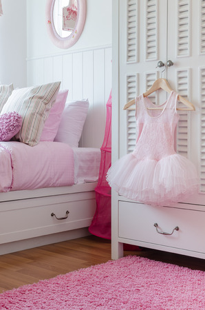 girl dress hanging on wardrobe in bedroom at homeの写真素材