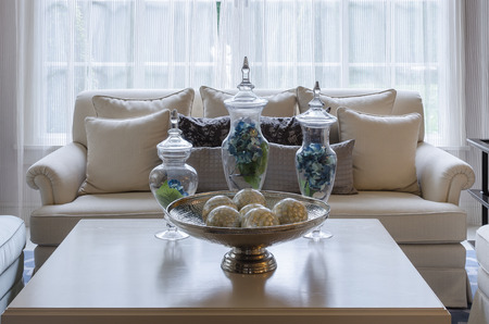 green leave in glass vase on table in luxury living roomの写真素材