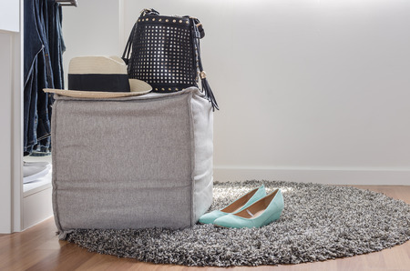 hat and bag on chair with shoes on carpet at homeの写真素材