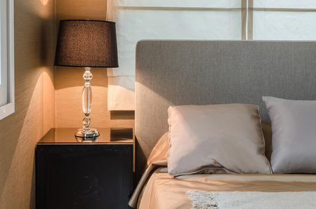 lamp on wooden table in bedroomの写真素材