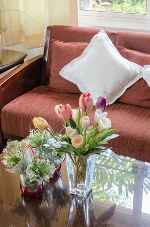 living room with flower in glass vase on glass tableの写真素材