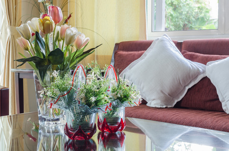 living room with red fabric sofa and flowerの写真素材