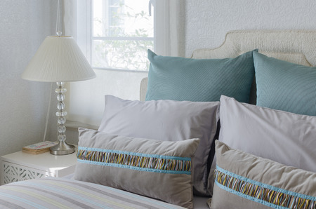 luxury bedroom with green pillows at homeの写真素材