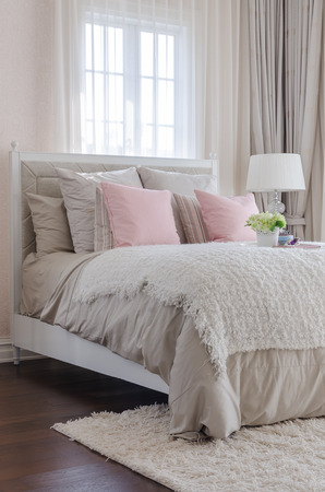 luxury bedroom with pink pillows on bed at homeの写真素材