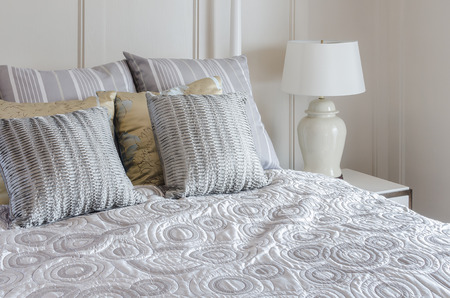 luxury king size bed in bedroom with white lampの写真素材