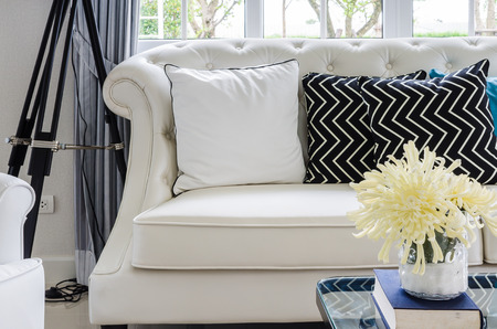 luxury sofa in living room with yellow flower in vase at homeの写真素材