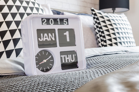 modern white alarm clock in bedroomの写真素材