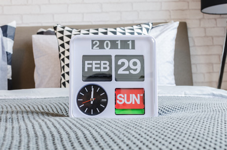 modern white alarm clock in modern bedroomの写真素材