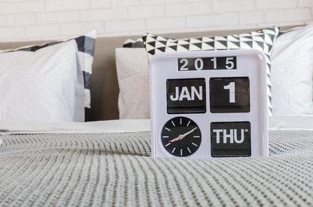 modern white alarm clock on bedの写真素材