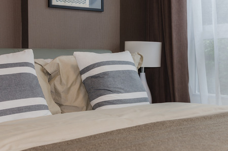 modern bedroom design with brown wallpaper at homeの写真素材