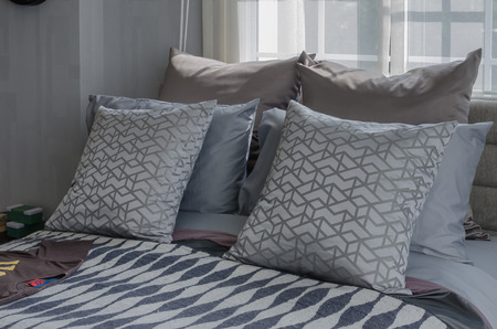 modern bedroom with shirts on bed