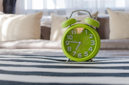 modern green alarm clock in bedroom at homeの写真素材