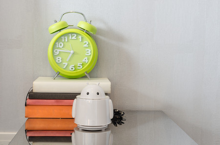 modern green alarm clock on books at homeの写真素材