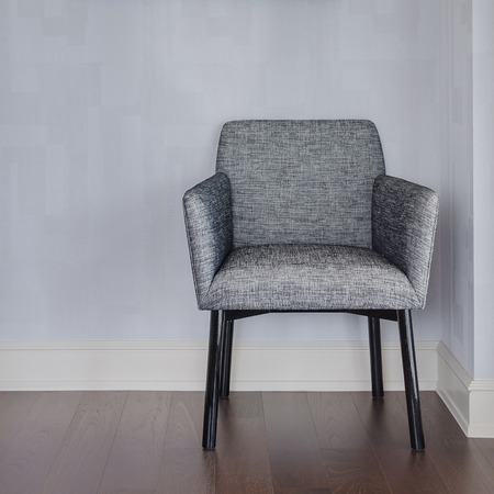 modern grey chair with blue wall and wood floor at homeの写真素材