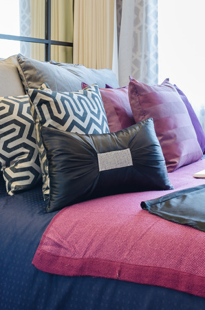 multicolor pillows on bed in bedroomの写真素材
