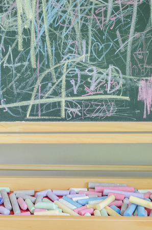 Multicoloured chalk and chalkboardの写真素材
