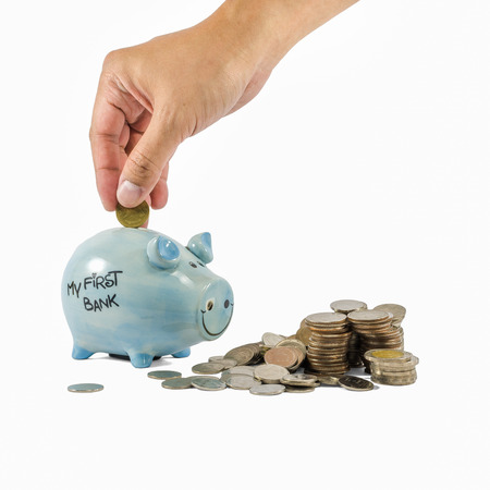 Piggybank and coins on white backgroundの写真素材